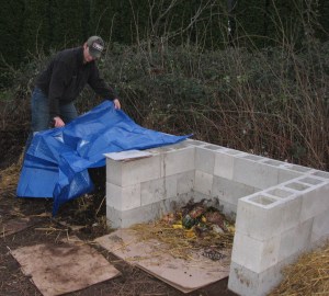 craig covering compost pile with tarp